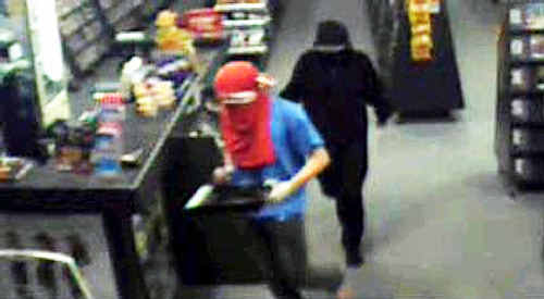 On candid camera: This CCTV footage shows two armed bandits at Network Video in Park Avenue on June 11. On candid camera: This CCTV footage shows two armed bandits at Network Video in Park Avenue on June 11.